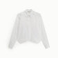 Camicia cropped con bottini e dettagli gioiello