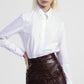 Camicia cropped con bottini e dettagli gioiello