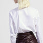 Camicia cropped con bottini e dettagli gioiello