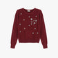 Maglione decorato con applicazioni floreali
