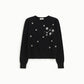 Maglione decorato con applicazioni floreali