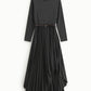 Abito lungo collo alto con gonna plissé asimmetrica