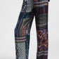 Pantaloni palazzo fantasia geometrica e floreale