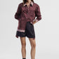Shorts con pannello sovrapposto e dettagli a righe