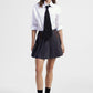 Gonna corta a pieghe con dettagli cinturini
