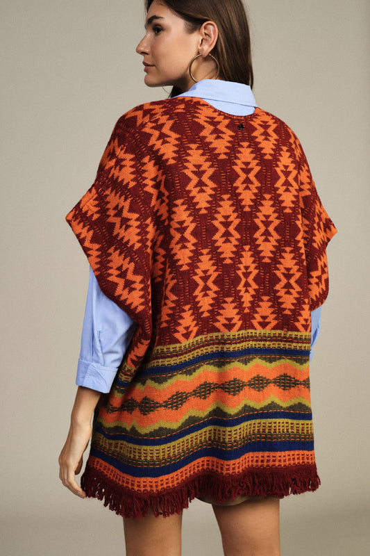 Poncho fantasia geometrica con frange